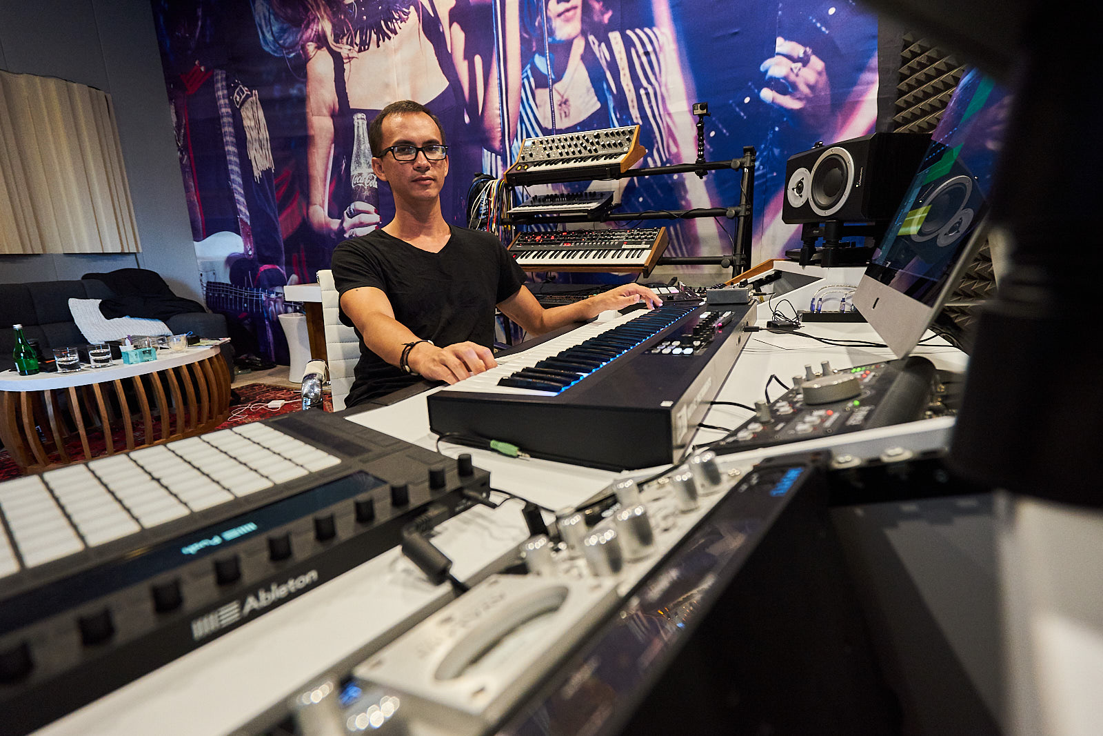 Christopher in professional music studio with keyboards and production equipment